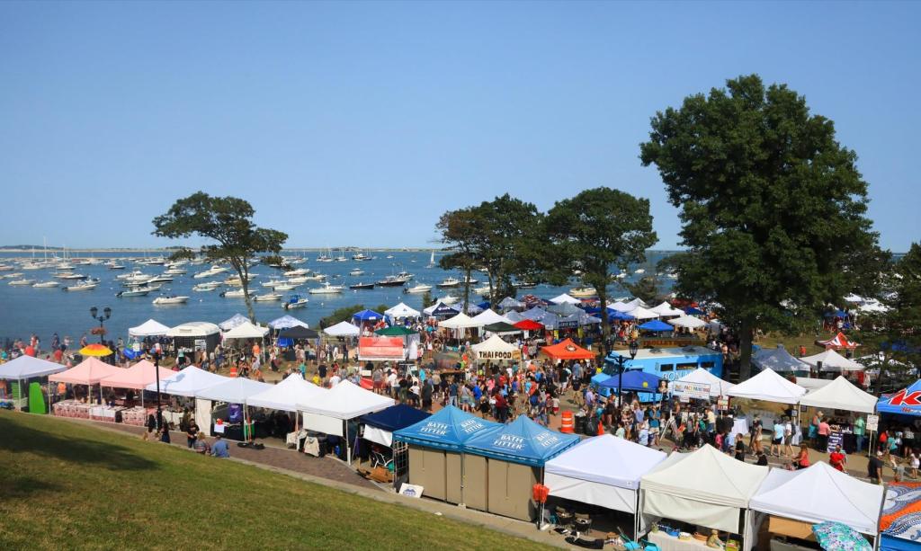 Plymouth waterfront festival with multiple booth vendors and food trucks